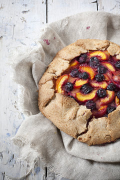 whole french galette with sliced apricots peaches blueberries