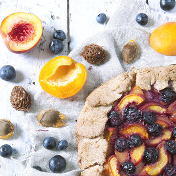 polaroid of wholemeal galette with blueberries peaches apricots