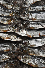 Plenty of small dried fishes on a stack