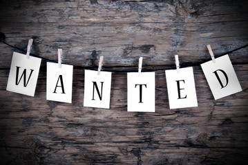 Wanted on Wooden Background