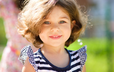Fototapeta premium Cute little girl is playing in playground