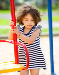 Young girl is playing in playground