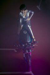 Sexy brunette woman wearing latex mounted on a motorcycle with a