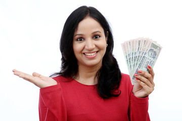 Young woman holding Indian currency