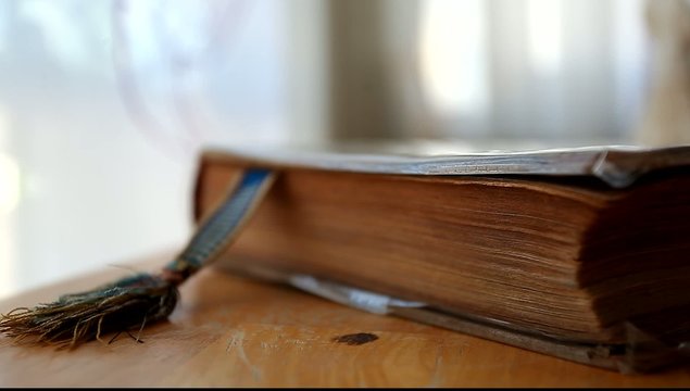 old book with bookmark on the table