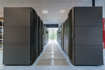 Servers and disk arrays arranged in racks - obrazy, fototapety, plakaty