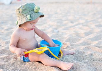 Toddler boy playing on the beach