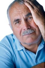 Lonely old man with hand on his face