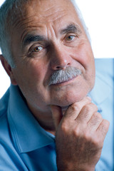 Eldery man with head resting on arms