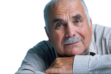 Eldery man with head resting on arms
