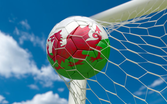 Wales flag and soccer ball in goal net