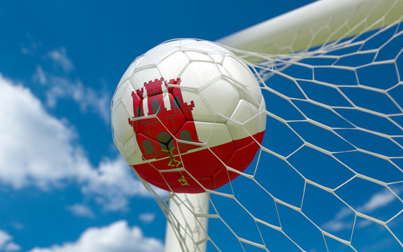 Gibraltar flag and soccer ball in goal net