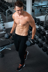 Fototapeta premium man doing exercises dumbbell bicep muscles