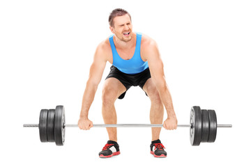 Bodybuilder struggling to lift a barbell