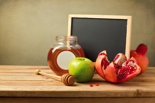 Honey, apple and pomegranate with chalkboard