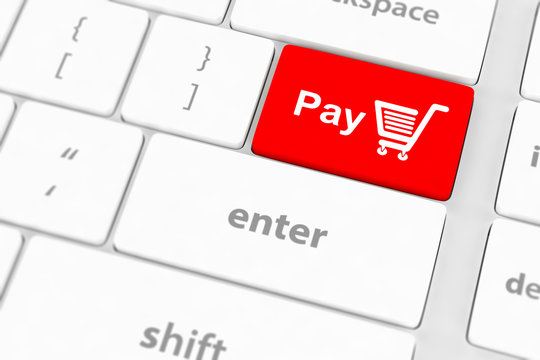 Pay key with shopping cart icon on a white keyboard