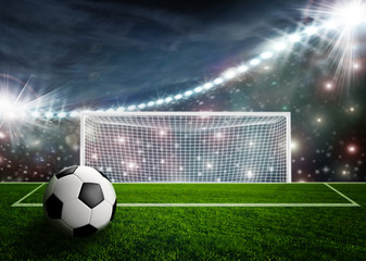 Soccer ball on green stadium arena