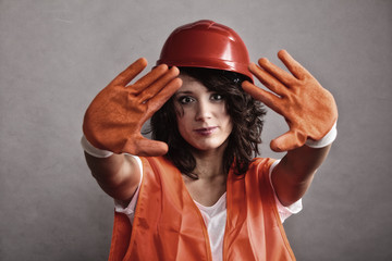 Sexy girl in safety helmet showing stop sign