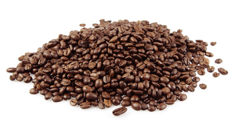 Pile of roasted coffee beans on white