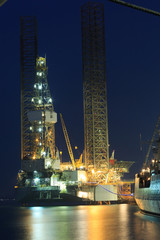 Fototapeta na wymiar Jack up oil drilling rig in the shipyard in the evening