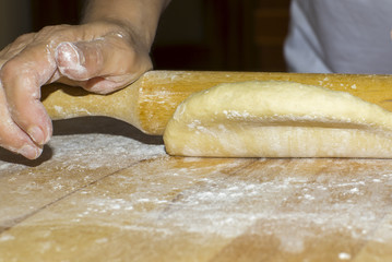 Hands with rolling kneading dough