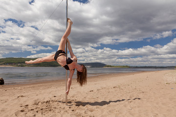 girl make pole dance in swimsuit
