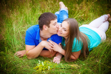 Fototapeta premium Romantic couple relaxing in field