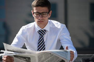 Businessman reading newspaper