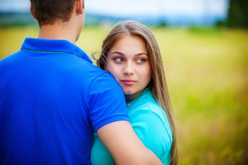 Romantic couple relaxing in field