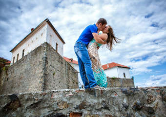 Fototapeta premium guy kissing the girlfriend against the old lock
