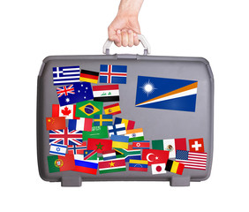 Used plastic suitcase with stickers