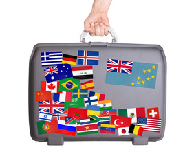 Used plastic suitcase with stickers