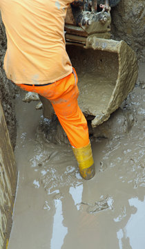 worker boots in brown mud during the flood 7