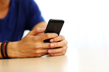 Closeup portrait of a male hands holding smartphone
