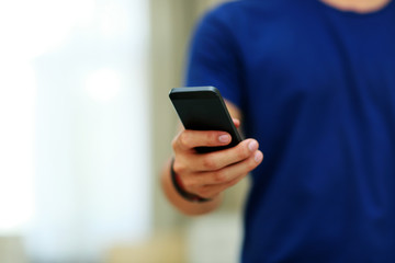 Closeup portrait of a male hands holding smartphone