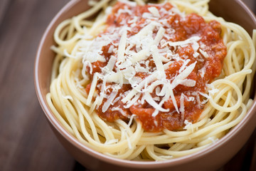 Close-up of spaghetti with bolognese sauce and parmesan cheese