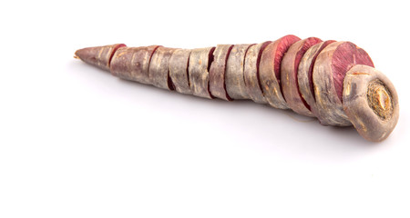 Chopped purple carrot over white background