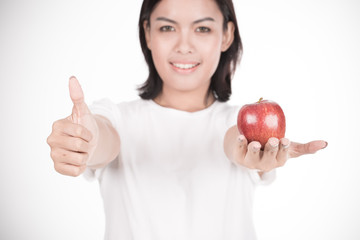 Smiling woman with apple isolated on white