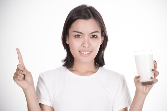 Laughing young woman with a glass of milk
