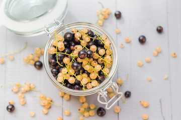fruits black and white currants jar wooden table