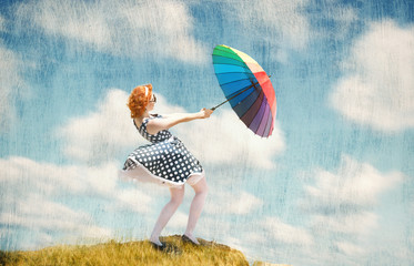 Retro style girl with colorful umbrella in the wind