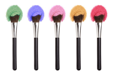 Cosmetics Makeup brushes with colorful powders.