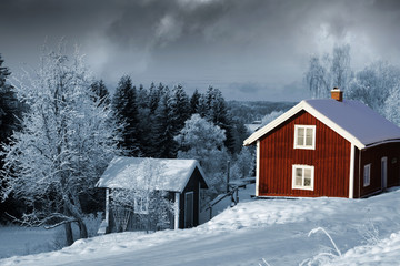 old red cottages in winter time, snowy swedish scenery