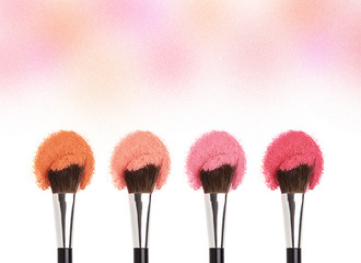 Cosmetics Makeup brushes with pink powder.