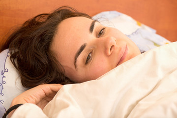Fototapeta na wymiar Young woman in bed