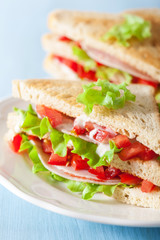 sandwich with ham tomato and lettuce