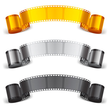Three scrolls of color movie tapes.