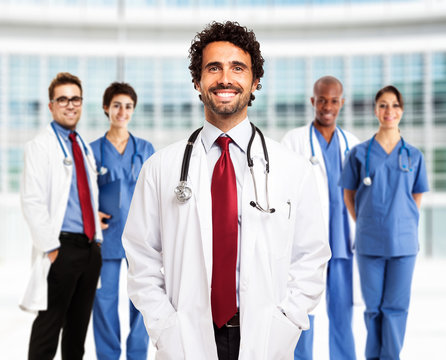 Smiling doctor in front of his team