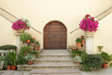 elegant doorsteps to italian villa decorated with many flowers