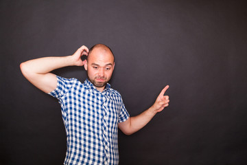 Fototapeta premium Young happy man pointing his finger